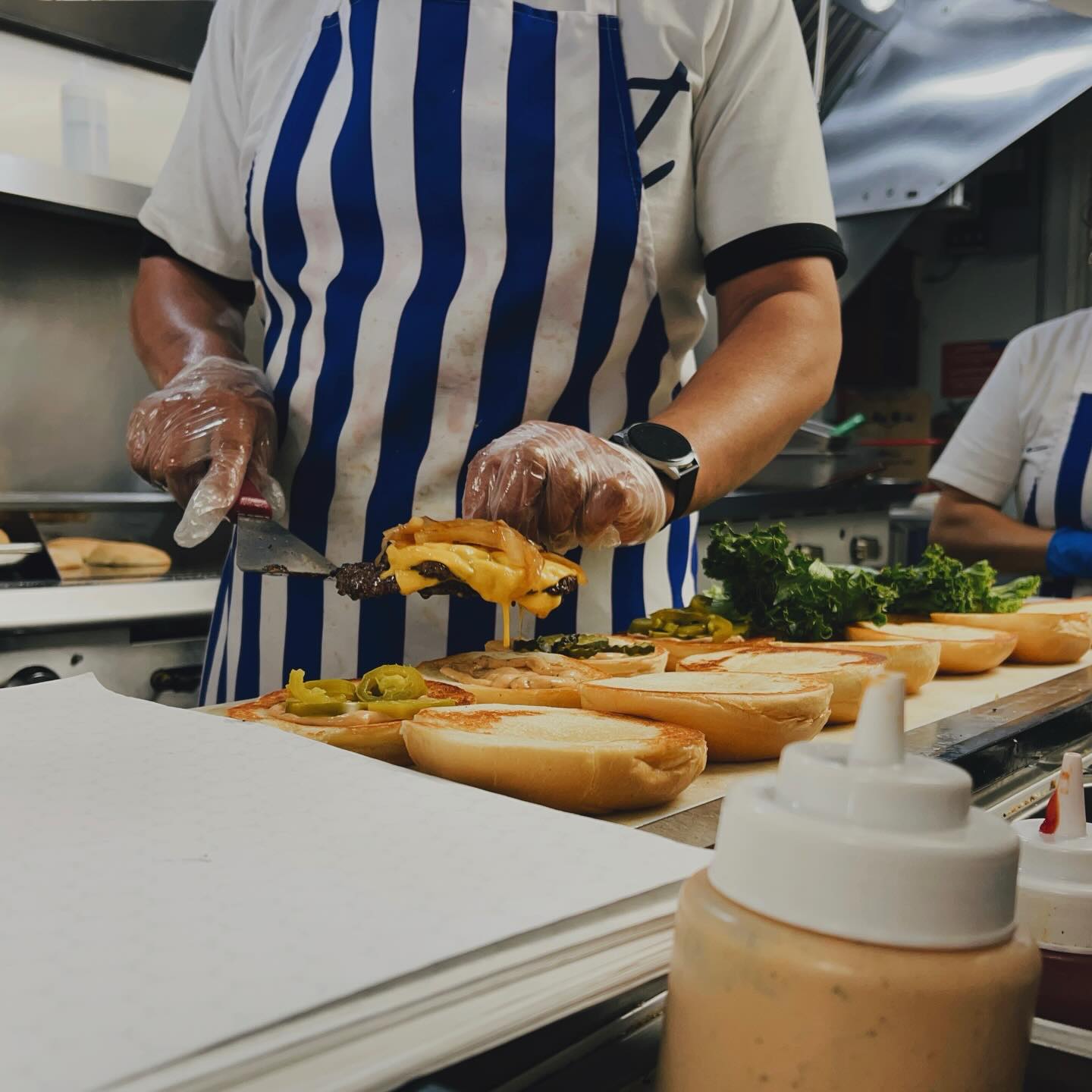 Chef assembling burgers at Provo Burger
